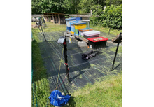 Load image into Gallery viewer, Base Camp Bear Sentry electric fence protecting apiary beehives in backyard